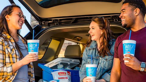 Three friends enjoying Circle K Polar Pop and snacks