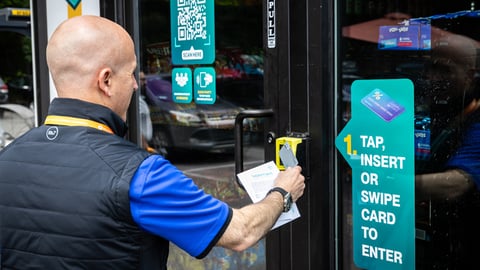 A man swiping his credit card to enter the Nomad