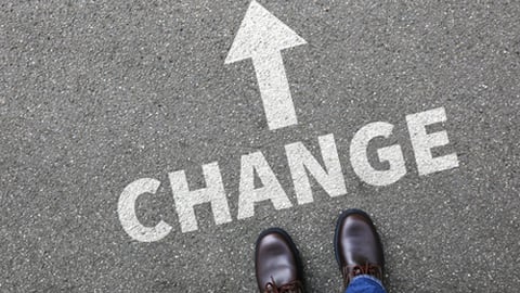 The word change written on pavement with an arrow