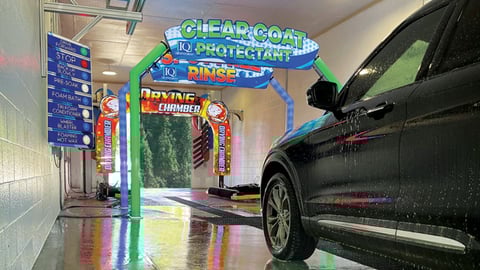 An SUV going through an IQ Express car wash