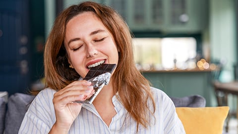 woman eating chocolate bar