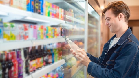 An European man but a bottle of mineral water from refrigerator cold in onvenience store for drink at home; Shutterstock ID 2218734615