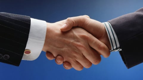 A handshake between two men in business suits