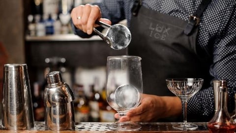 Bartender using Lux Ice balls for cocktails