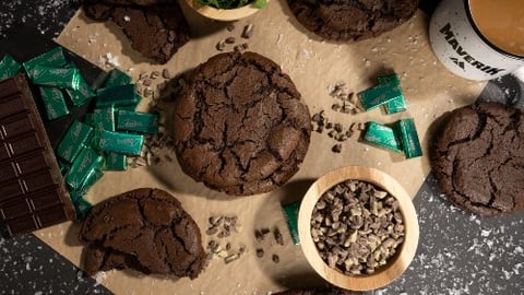 Maverik Mint Stuffed Cookies on a tray with coffee