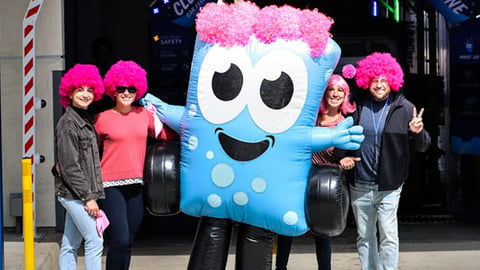 Soapy Joe's mascot and customers wearing pink wigs