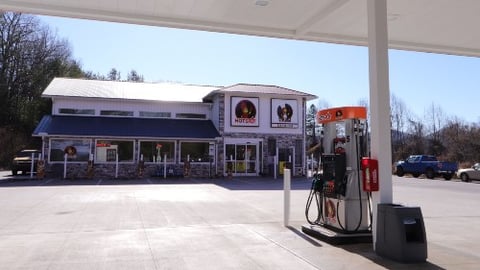 Exterior of Hot Spot convenience store with gas pump in foreground 