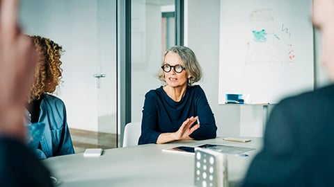 Older woman in office meeting