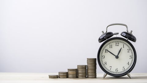 A clock with stacks of coins