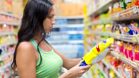 A woman buying a bag of chips