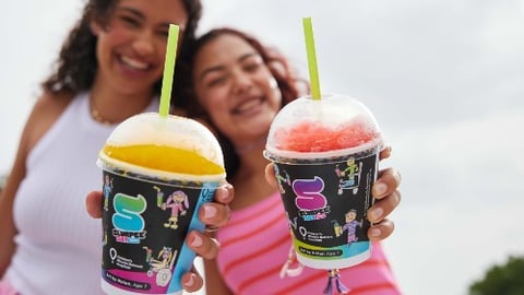 Mother and daughter holding small Slurpees toward the camera