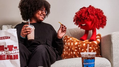 Woman sitting on couch looking her inner Sheetz Freakz