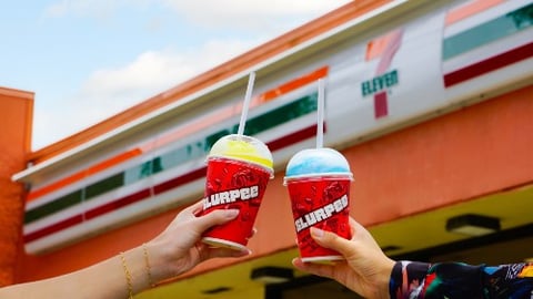 Two hands holding Slurpees outside a 7-Eleven in Hawaii