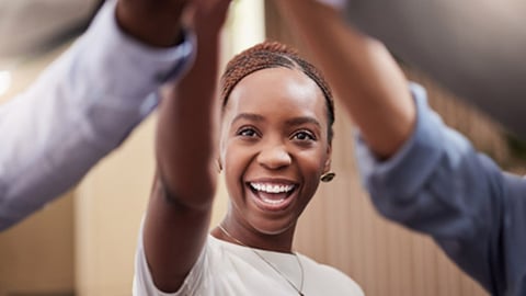 A woman celebrating an achievement with colleagues