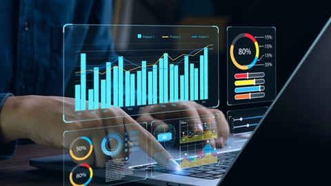 A person on a computer with images of data graphs