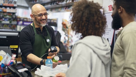 A store clerk checking out customers