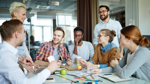 A group of happy employees sitting around an office table