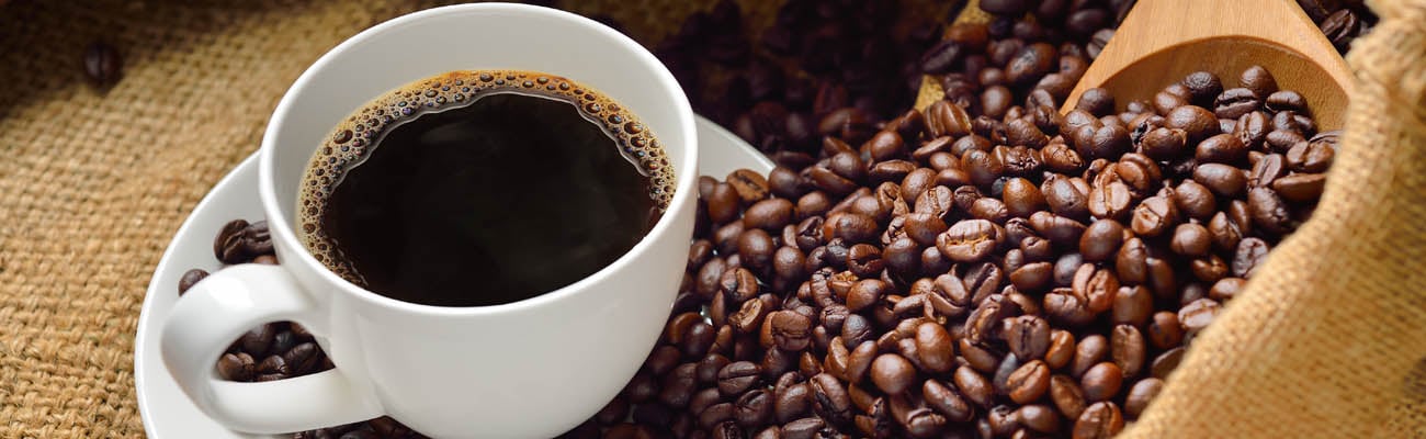 A coffee cup and coffee beans