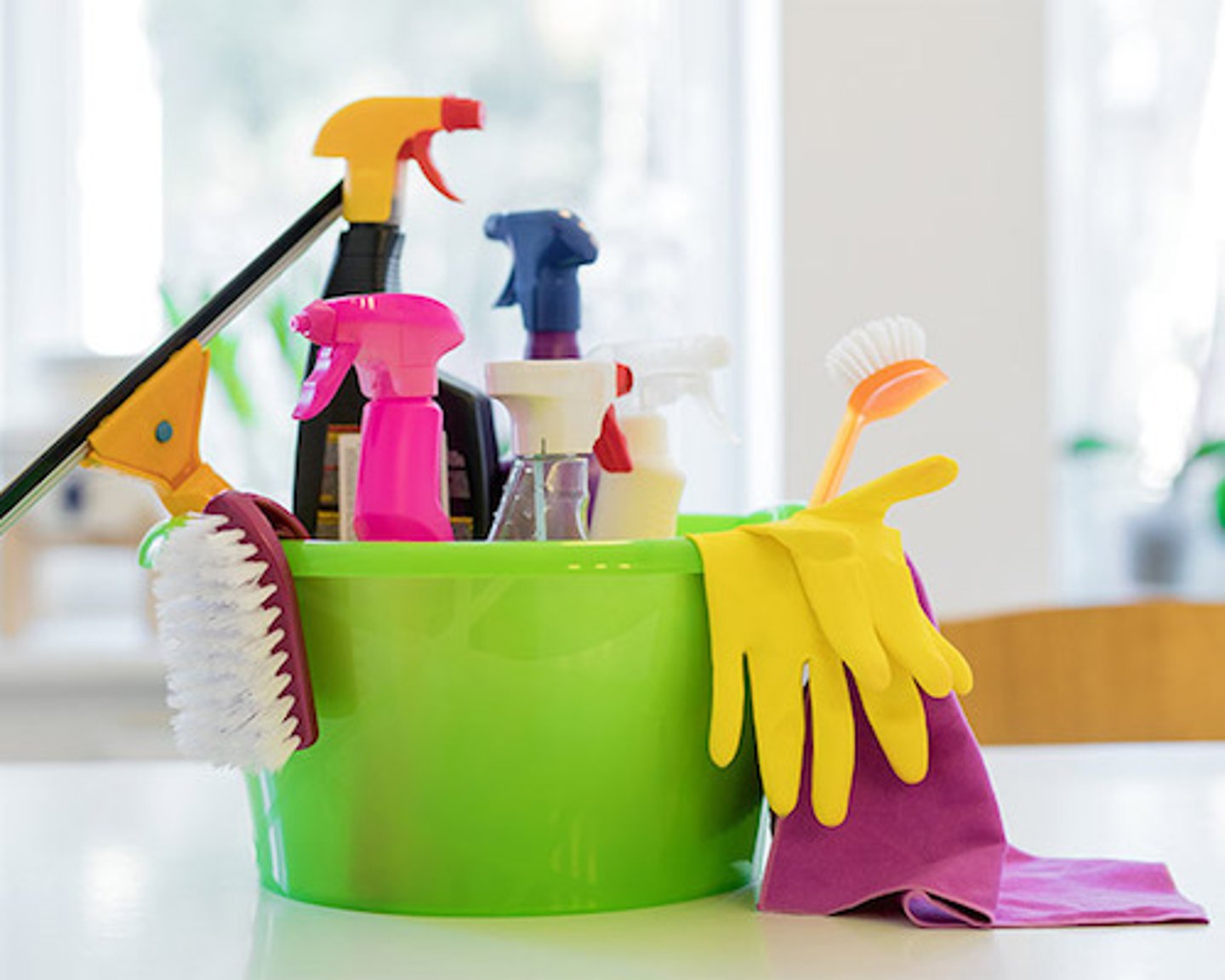 cleaning supplies in a bucket with gloves