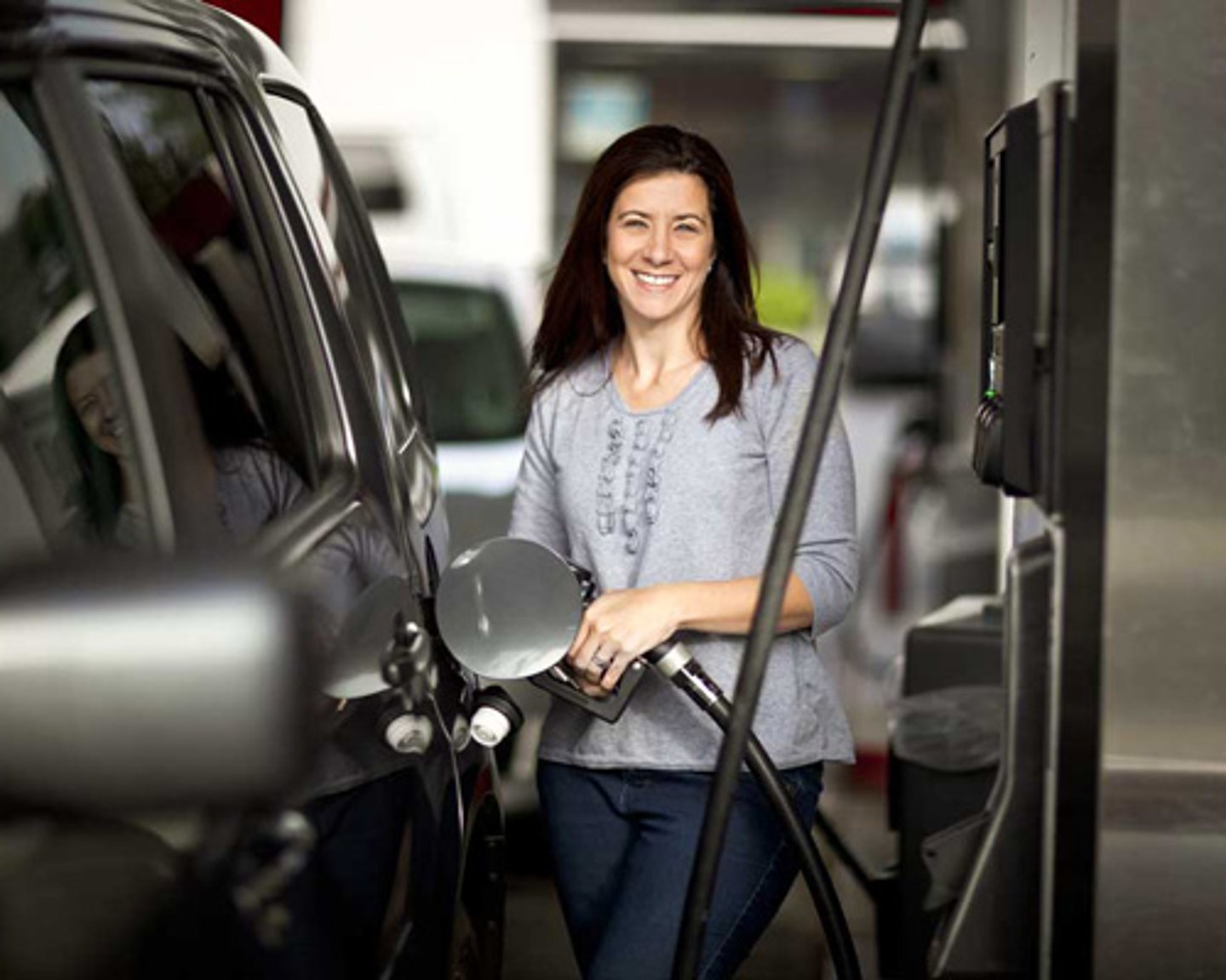 female pumping gas