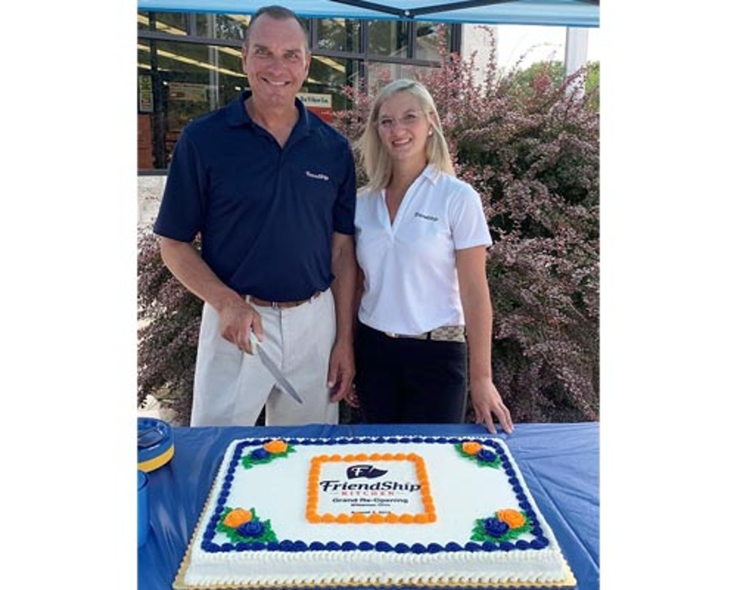 Dean Beck, senior vice president business development and co-owner, and Chelsea Carvalho, retail operations, celebrate the grand re-opening of a Friendship Kitchen in Wakeman, Ohio.