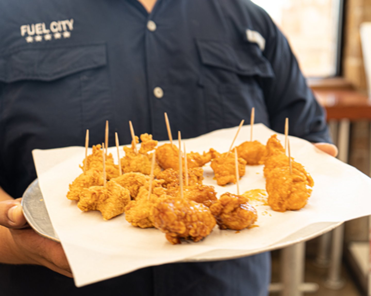 Fuel City employee handing out Chester's Chicken samples