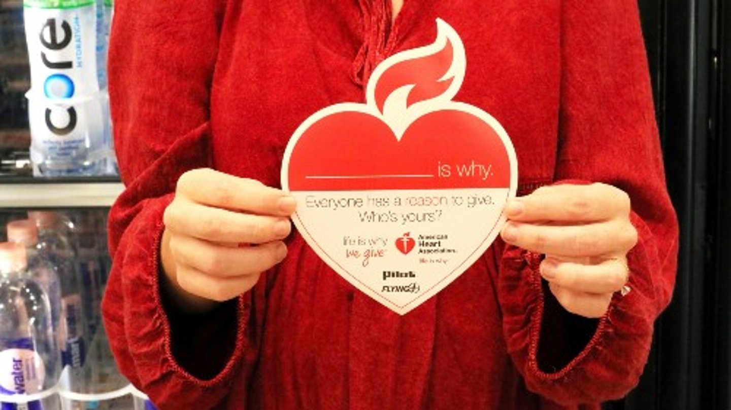 Hands holding a paper heart for the American Heart Association