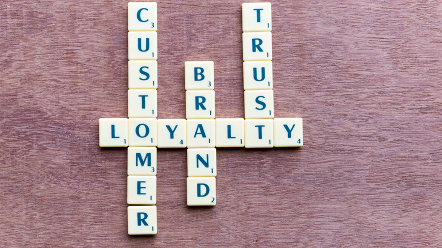 Scrabble tiles spell out customer, loyalty, trust and brand
