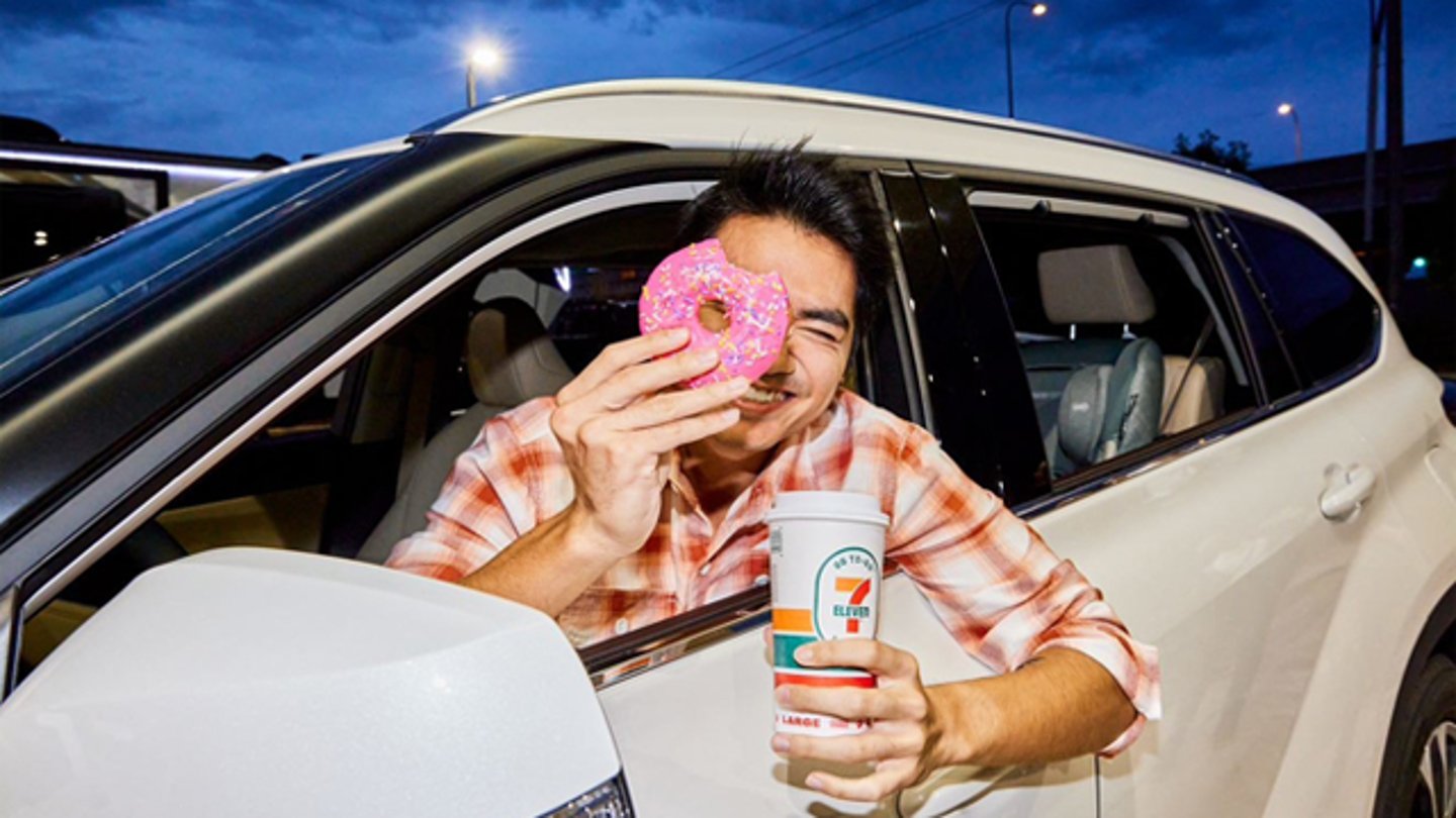 A 7-Eleven customer in a car with a donut