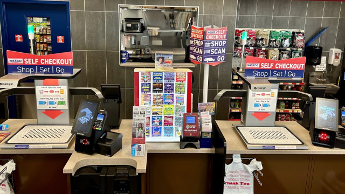 Self-checkout kiosks at a Wesco store