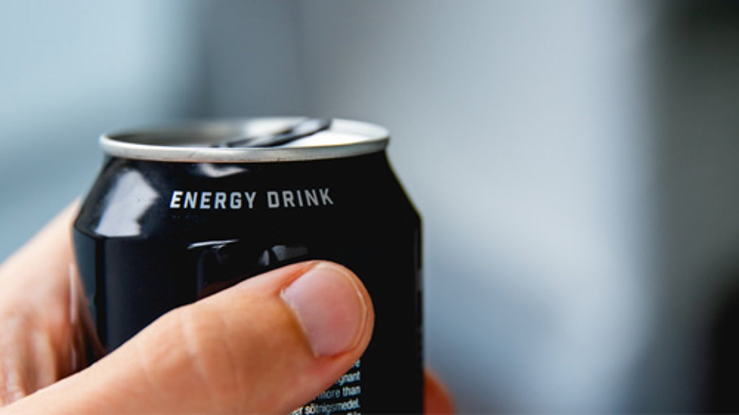 A person holding an energy drink