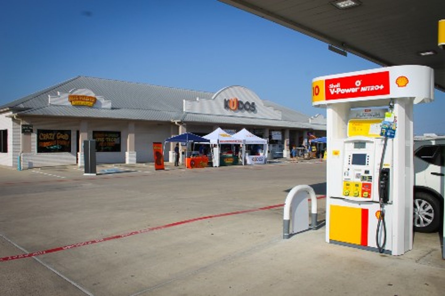 Gas pump in the forecourt of a Kudos parking lot 