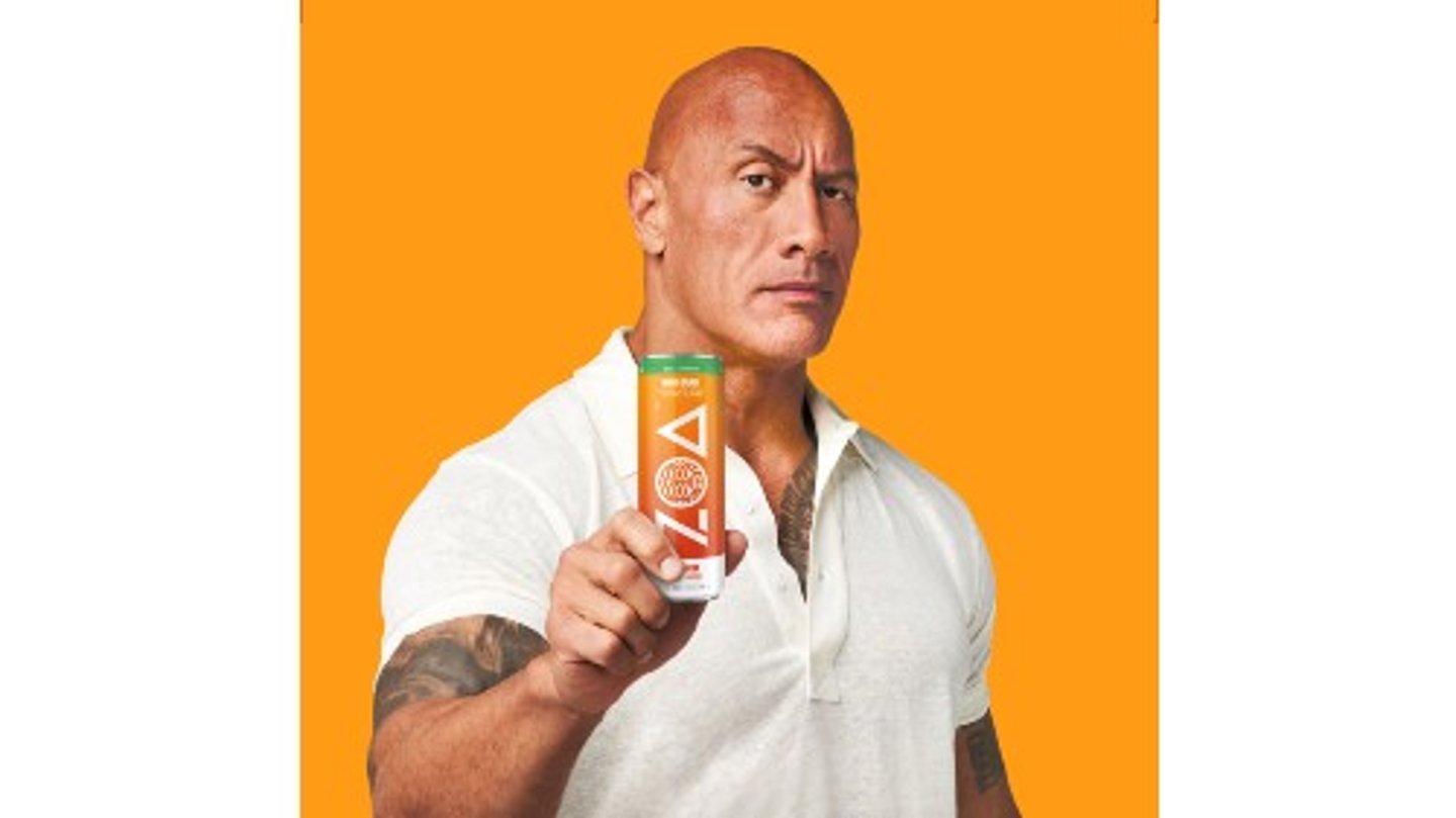 The Rock holds up a can of ZOA Energy Mango Splash