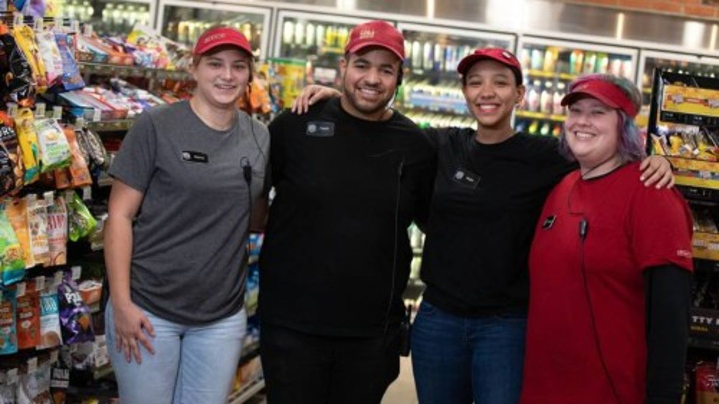 Four happy employees at a Sheetz store