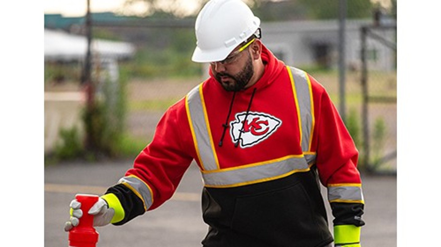 Worker wearing reflective hoodie with Kansas City Chiefs logo from Love's 