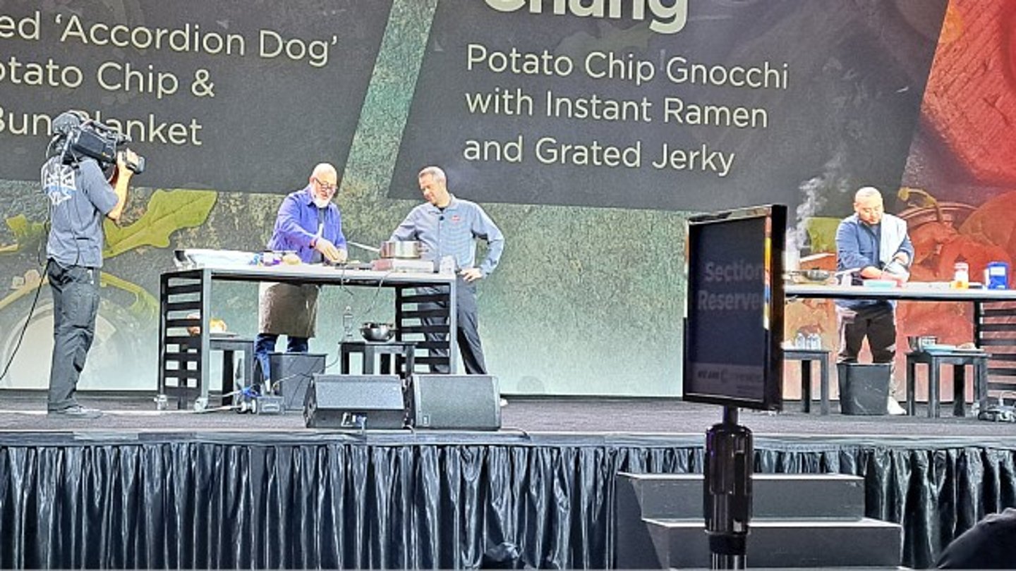 Andrew Zimmerman and David Chang cooking on stage at the 2024 NACS Show