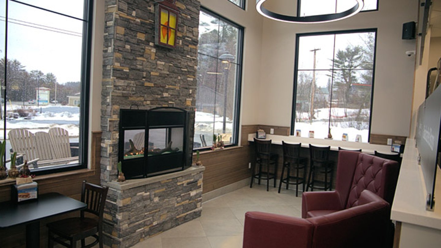 A cozy fireplace and seating inside Rusty Lantern Market